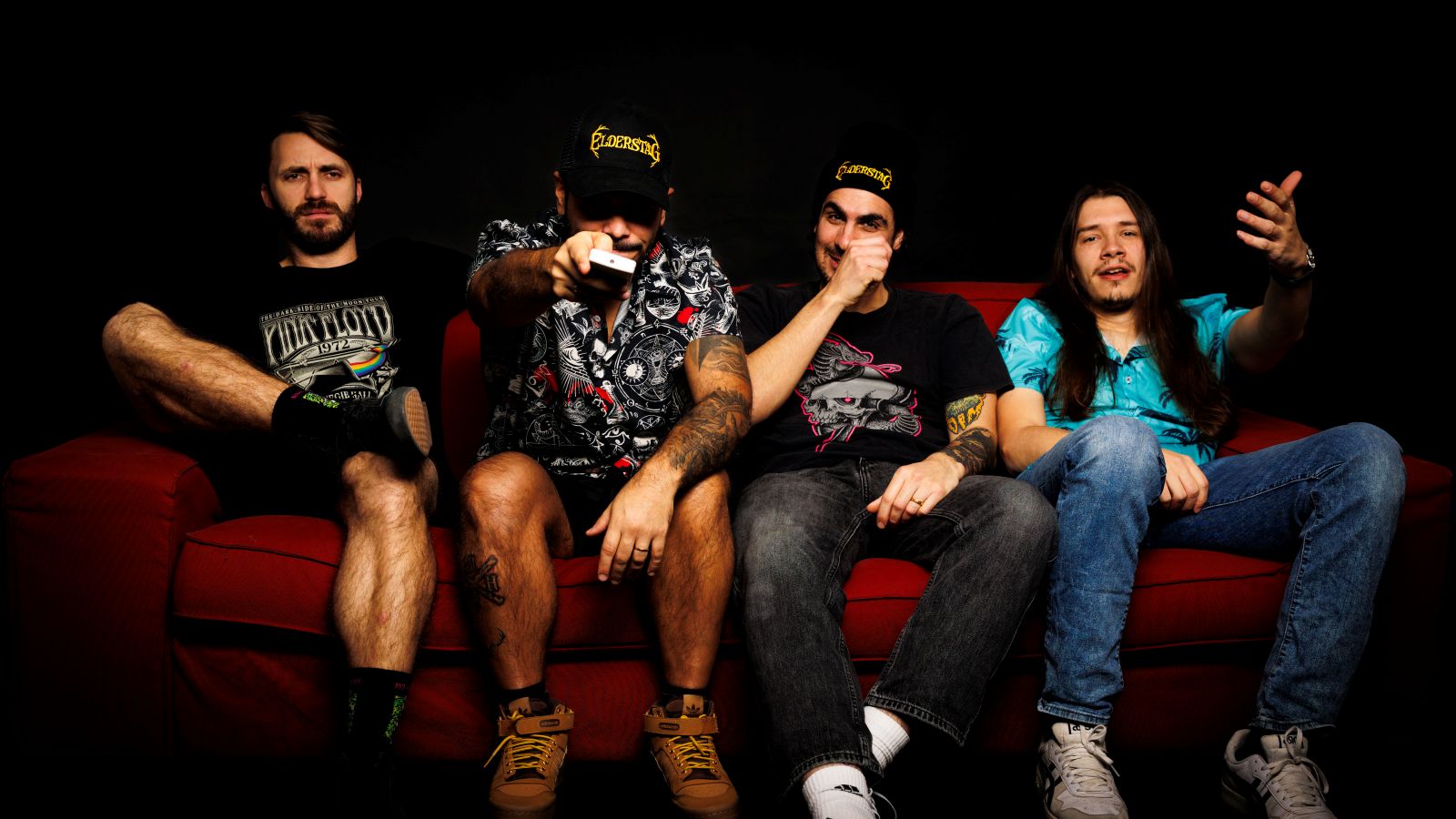 The four members of Elderstag on a red sofa